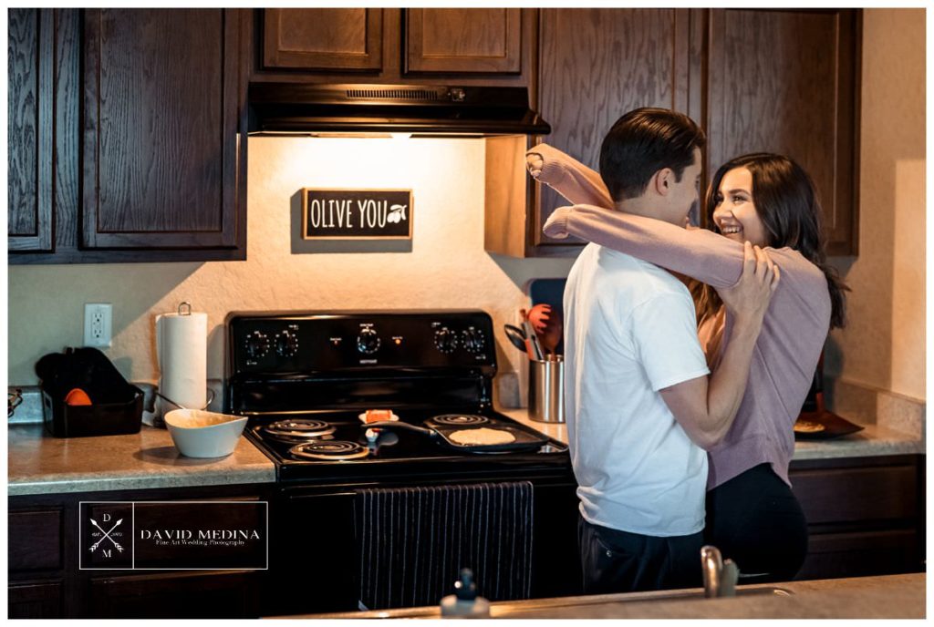 Couple hugging in the kitchen.